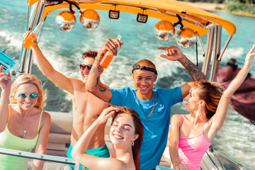 Young people drinking and dancing on the deck