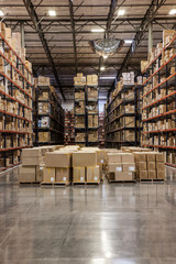 Cardboard boxes on pallets in distribution warehouse