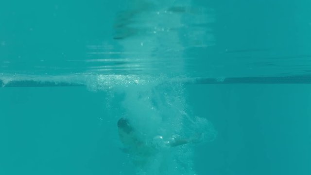little boy jumping in swimming pool submerged underwater splashing having fun on sunny day happy child enjoying summer vacation at holiday home 4k