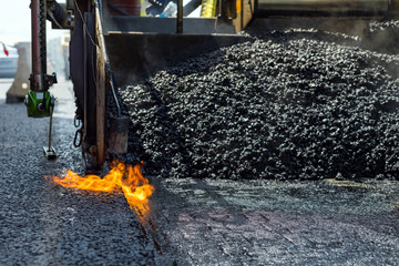 Construction and repair road. Technology and principles of joining road asphalt pavements using asphalt paver machine. - obrazy, fototapety, plakaty