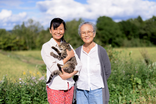 Portrait of mother and daughter standing outdoors