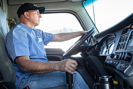 Side view of truck driver driving truck