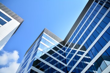 modern office building with blue sky and clouds