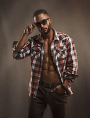 Handsome Male Model With Sunglasses Wearing Unbuttoned Shirt Exposing His Muscular Torso