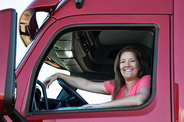 Portrait of smiling woman sitting in commercial truck