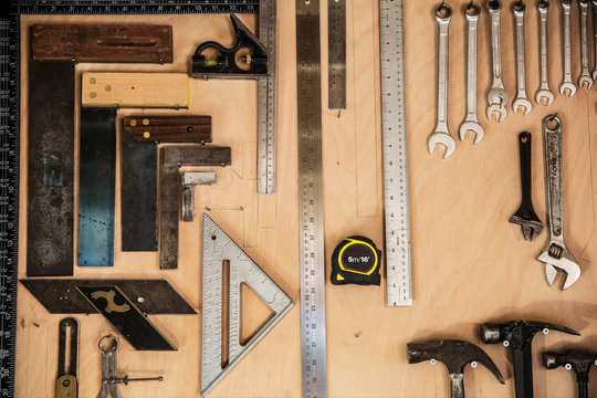 Close up of variety of tools hanging on wall in workshop