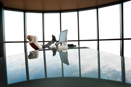 Side view of businessman relaxing in office