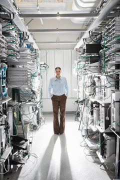 Portrait of technician standing in computer server room