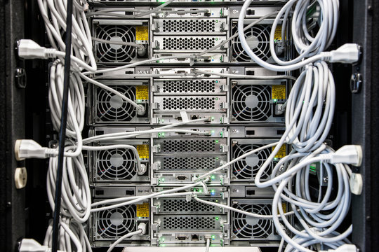 Close up of cat 5 cables hooked to servers in computer server room