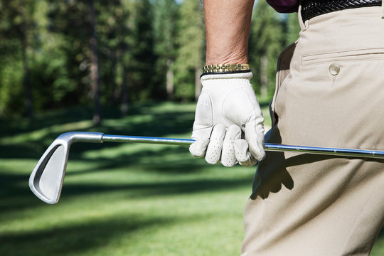 Close up of man holding golf club