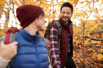 Attractive caucasian couple hiking through the forest in the fall in Canada