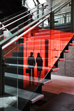 Reflection of businessman and businesswoman on glass