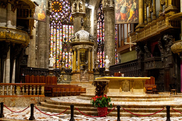 Naklejka premium Milano, Italy. 2017/12/12. The altar with stained glass windows in the background. Duomo di Milano (Milan Cathedral)