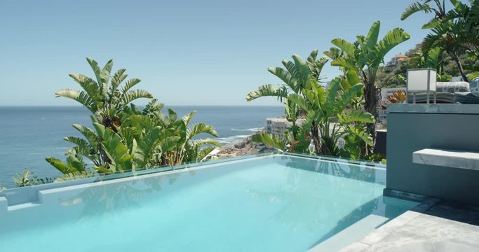 beautiful swimming pool in luxury hotel with view of ocean exotic holiday resort destination on sunny day with palm trees summer vacation travel 4k
