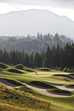 View of golfer standing on golf course