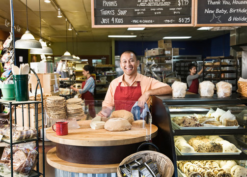 Portrait of smiling baker standing in bakery