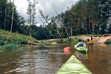 A woman kayaking down the river.