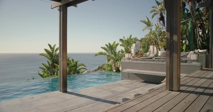 sexy woman taking off clothes jumping in swimming pool at luxury hotel enjoying swim at tropical resort with ocean view having fun summer vacation on warm sunny day mediterranean travel 4k