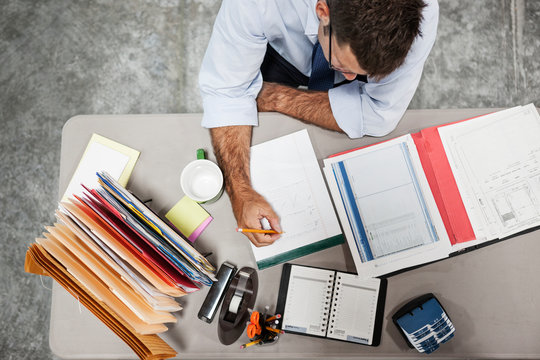 Overhead view of architect working in warehouse