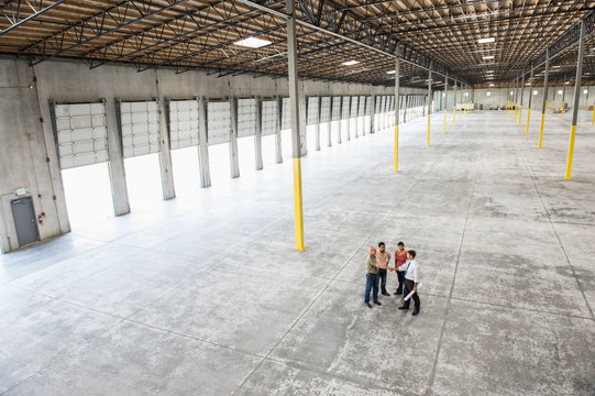 Architects checking out interior of warehouse