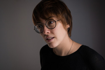 Portrait of girl with brown short hair looking away with a thoughtful expression