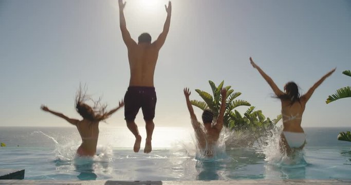 travel friends jumping in swimming pool at luxury hotel resort celebrating summer vacation enjoying sunny day on holiday 4k