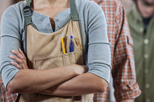 Midsection of workers standing in workshop
