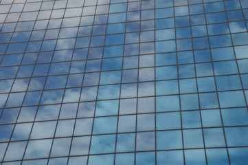 Skyscrapers modern windows and mirrored sky in it