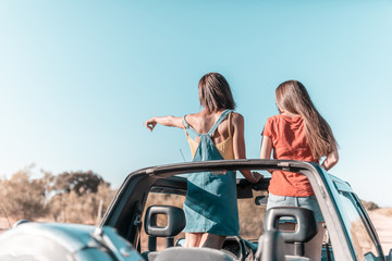 Fototapeta na wymiar beautiful girls and young people traveling with the jeep car