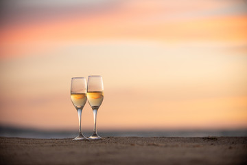 glass of wine on the beach at sunset