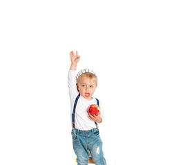 Baby boy eating apple and smiling in the studio isolated on white background