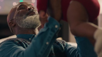 african american family christmas grandfather holding baby girl giving kiss proud of granddaughter happy grandparents enjoying festive holiday reunion at home 4k - Powered by Adobe