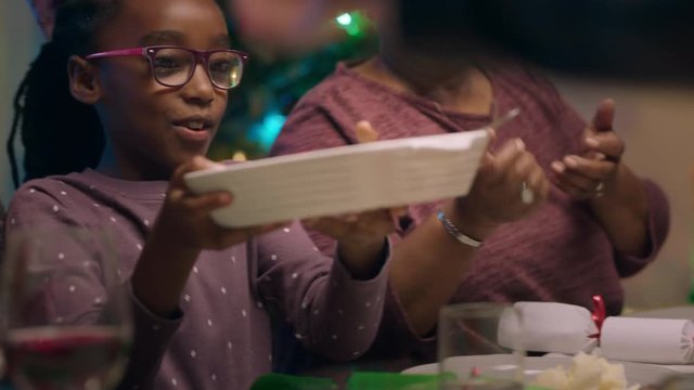 little african american girl enjoying christmas dinner with family eating delicious homemade meal sharing holiday feast at home 4k footage
