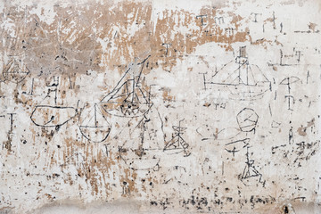 Close up of 18th century graffiti of sailboats on wall