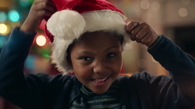 portrait little african american girl celebrating christmas wearing hat smiling enjoying festive holiday having fun evening at home 4k 