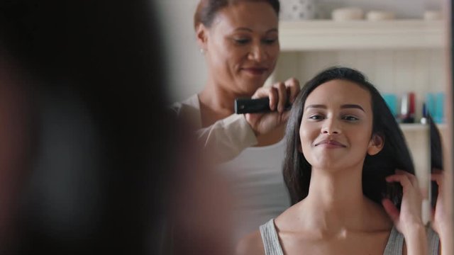 Mother Brushing Daughters Hair Beautiful Teenage Girl Getting Ready Looking At Mirror In Bathroom With Mom Helping With Hairstyle 4k