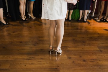 Legs of women with party shoes.