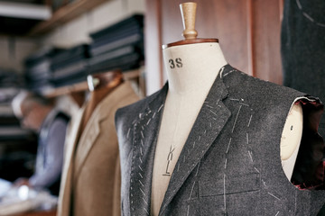 Handmade stitching suit hanging on mannequin