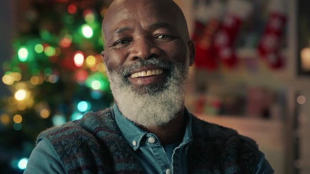 portrait old african american man laughing celebrating christmas at home enjoying festive holiday season 4k