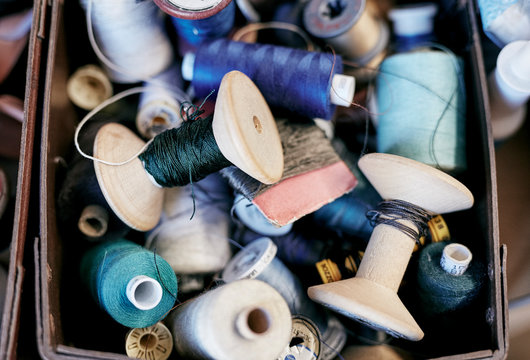 Box of colored sewing threads reels