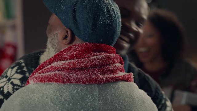 african american grandparents visiting for christmas hugging family giving presents enjoying festive holiday celebration on winter evening at home 4k footage