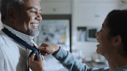 teenage girl helping father with tie getting ready for work at home 4k footage