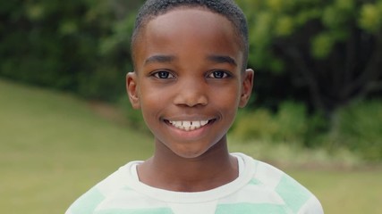portrait cute african american boy smiling with playful excitement looking happy having fun in sunny park outdoors enjoying childhood testimonial concept 4k footage - Powered by Adobe