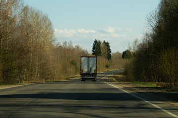 Delivery truck driving on a highway. car moving on a roadway