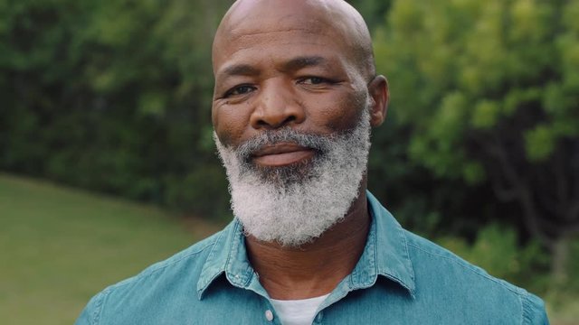 portrait old african american man looking happy in park enjoying successful retirement lifestyle testimonial concept 4k
