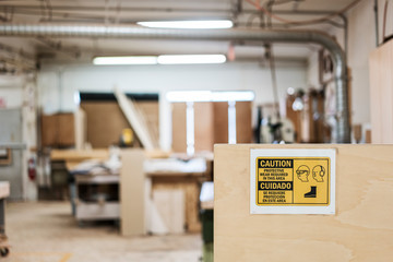 Warning sign for safety gear regulations in workshop