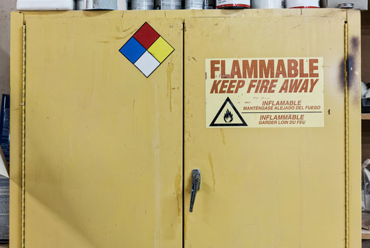 Safety sign on metal cabinet in workshop