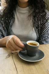 Close up of woman's hand holding cup of coffee