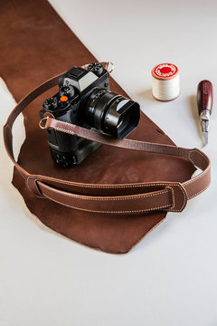 Vintage camera with leather strap and tool