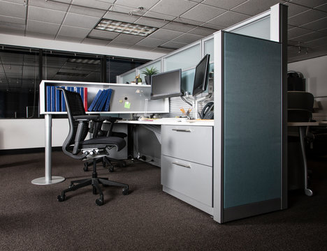 Interior view of cubicle office space at night